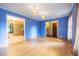 Bright living room showcasing hardwood floors, blue walls, pendant lighting, and open doorways at 1236 S Shadygrove Ct, Stone Mountain, GA 30083