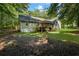 View of the home's rear exterior, with a deck and wooded backyard offering privacy and outdoor living space at 820 Airline Rd, Mcdonough, GA 30252