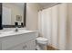Clean bathroom featuring a white vanity, toilet, and shower with a patterned curtain at 820 Airline Rd, Mcdonough, GA 30252