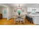 Light and airy dining area featuring hardwood floors and white trim with access to the kitchen at 820 Airline Rd, Mcdonough, GA 30252
