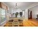 Cozy dining area with a chandelier, light-colored table, and a view to the kitchen with white cabinets at 820 Airline Rd, Mcdonough, GA 30252