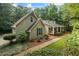 Charming exterior view of a two-story home with a inviting front porch and meticulously landscaped yard at 820 Airline Rd, Mcdonough, GA 30252
