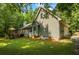 Exterior side view with lush lawn, showing the attached garage, chimney, and well-maintained siding at 820 Airline Rd, Mcdonough, GA 30252