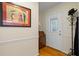 Foyer featuring a coat rack, cabinet, and framed art, complemented by hardwood floors at 820 Airline Rd, Mcdonough, GA 30252