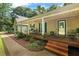 Inviting front porch with classic rocking chairs, complemented by lush landscaping and warm wood accents at 820 Airline Rd, Mcdonough, GA 30252