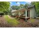 Home exterior showing the lush lawn, mature trees, and inviting covered porch at 820 Airline Rd, Mcdonough, GA 30252