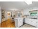 Open kitchen design with white cabinets, a breakfast bar and view into dining space at 820 Airline Rd, Mcdonough, GA 30252