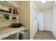 Laundry area featuring upper shelving with a drop-in sink, side-by-side washer and dryer, and storage space at 820 Airline Rd, Mcdonough, GA 30252