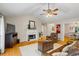 Bright living room features hardwood floors, a marble fireplace, and seamless flow to dining area at 820 Airline Rd, Mcdonough, GA 30252