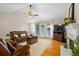 Inviting living room with a fireplace, hardwood floors, leather furniture, and French doors at 820 Airline Rd, Mcdonough, GA 30252
