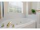 Bright and sunny bathroom with soaking tub and shiny brass fixtures at 820 Airline Rd, Mcdonough, GA 30252