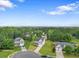 An aerial shot reveals a lovely home nestled in a serene neighborhood with verdant trees at 140 Canyons Ct, Hampton, GA 30228