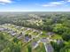 Scenic aerial view of a residential area with well-maintained homes surrounded by lush greenery and trees at 140 Canyons Ct, Hampton, GA 30228