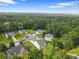 Neighborhood aerial view showing trees and nicely kept homes in a suburban setting at 140 Canyons Ct, Hampton, GA 30228