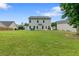 A spacious backyard provides ample green space, complemented by the home's rear facade at 140 Canyons Ct, Hampton, GA 30228