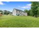 Expansive backyard featuring a well-maintained lawn and views of the home's exterior at 140 Canyons Ct, Hampton, GA 30228