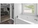 Bathroom features a large soaking tub, a shower, and access to main bedroom at 140 Canyons Ct, Hampton, GA 30228