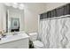 Bathroom with white vanity, toilet, and shower with patterned curtain at 140 Canyons Ct, Hampton, GA 30228