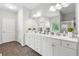 Bright bathroom features a large vanity, double sinks, a shower, and decorative accents at 140 Canyons Ct, Hampton, GA 30228