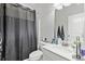 Bathroom featuring a grey shower curtain and white vanity at 140 Canyons Ct, Hampton, GA 30228