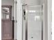 Bright bathroom features a glass shower door, a ceiling fan, and a large vanity with a mirror at 140 Canyons Ct, Hampton, GA 30228