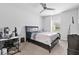 Bedroom with a ceiling fan, desk, dresser and a large window at 140 Canyons Ct, Hampton, GA 30228