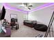 Bedroom with a trundle bed, bean bag chair, and colorful LED ceiling lights at 140 Canyons Ct, Hampton, GA 30228