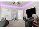 Bedroom featuring LED ceiling lights, a desk, and a large screen television at 140 Canyons Ct, Hampton, GA 30228