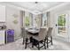 Cozy dining area with stylish furniture, modern lighting, and convenient access to outdoor views at 140 Canyons Ct, Hampton, GA 30228
