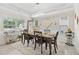 Bright dining room featuring a modern chandelier, ample natural light, and stylish decor at 140 Canyons Ct, Hampton, GA 30228
