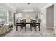 Bright dining room featuring a modern chandelier, ample natural light, and stylish decor at 140 Canyons Ct, Hampton, GA 30228