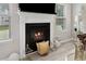 Fireplace with white mantle and black interior with decor and mounted television at 140 Canyons Ct, Hampton, GA 30228