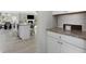 View from the kitchen showing island, dining area and into the living room at 140 Canyons Ct, Hampton, GA 30228