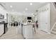 Open-concept kitchen with a large island, stainless steel appliances, and modern finishes at 140 Canyons Ct, Hampton, GA 30228