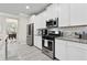 Kitchen with white cabinets, subway tile backsplash and stainless steel appliances at 140 Canyons Ct, Hampton, GA 30228