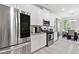 Bright kitchen with stainless steel appliances, granite countertops, and white cabinets at 140 Canyons Ct, Hampton, GA 30228