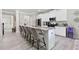 Kitchen with long island with bar stool seating and modern stainless appliances at 140 Canyons Ct, Hampton, GA 30228