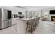 Bright, open kitchen with a large island, stainless steel appliances, and a clear view to living area at 140 Canyons Ct, Hampton, GA 30228