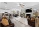 Open-concept floor plan with living room featuring a fireplace and view to the kitchen and dining room at 140 Canyons Ct, Hampton, GA 30228