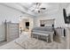 Spacious bedroom with ceiling fan, decorative furniture, and ensuite bathroom entrance at 140 Canyons Ct, Hampton, GA 30228
