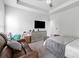 Bright main bedroom with ceiling fan and a leather loveseat at 140 Canyons Ct, Hampton, GA 30228