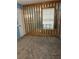 Carpeted bedroom separated by a wooden partition and a window with blinds at 1455 Stone Mill Trce, Stone Mountain, GA 30083