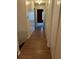 Hallway boasts hardwood floors and multiple closets leading to a red bedroom at 1455 Stone Mill Trce, Stone Mountain, GA 30083