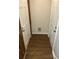 Small hallway showing two closed doors and hardwood flooring at 1455 Stone Mill Trce, Stone Mountain, GA 30083