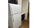 View of a kitchen area featuring a white refrigerator, white countertop, and view into another room at 1455 Stone Mill Trce, Stone Mountain, GA 30083