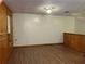 Image of a living room with hardwood floors and white walls accented by wood paneling at 1455 Stone Mill Trce, Stone Mountain, GA 30083