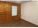 Shows a living room with white walls and hardwood floors, accented by wood paneling and a window at 1455 Stone Mill Trce, Stone Mountain, GA 30083