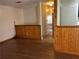 Image shows a living room with hardwood floors and wood paneling half-way up the wall at 1455 Stone Mill Trce, Stone Mountain, GA 30083