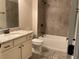 Bathroom with granite countertop, white cabinets, tub with tile surround, and tiled floors at 1790 Nestledown Dr, Cumming, GA 30040
