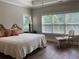 Bedroom features a large window and hard wood floors at 1790 Nestledown Dr, Cumming, GA 30040